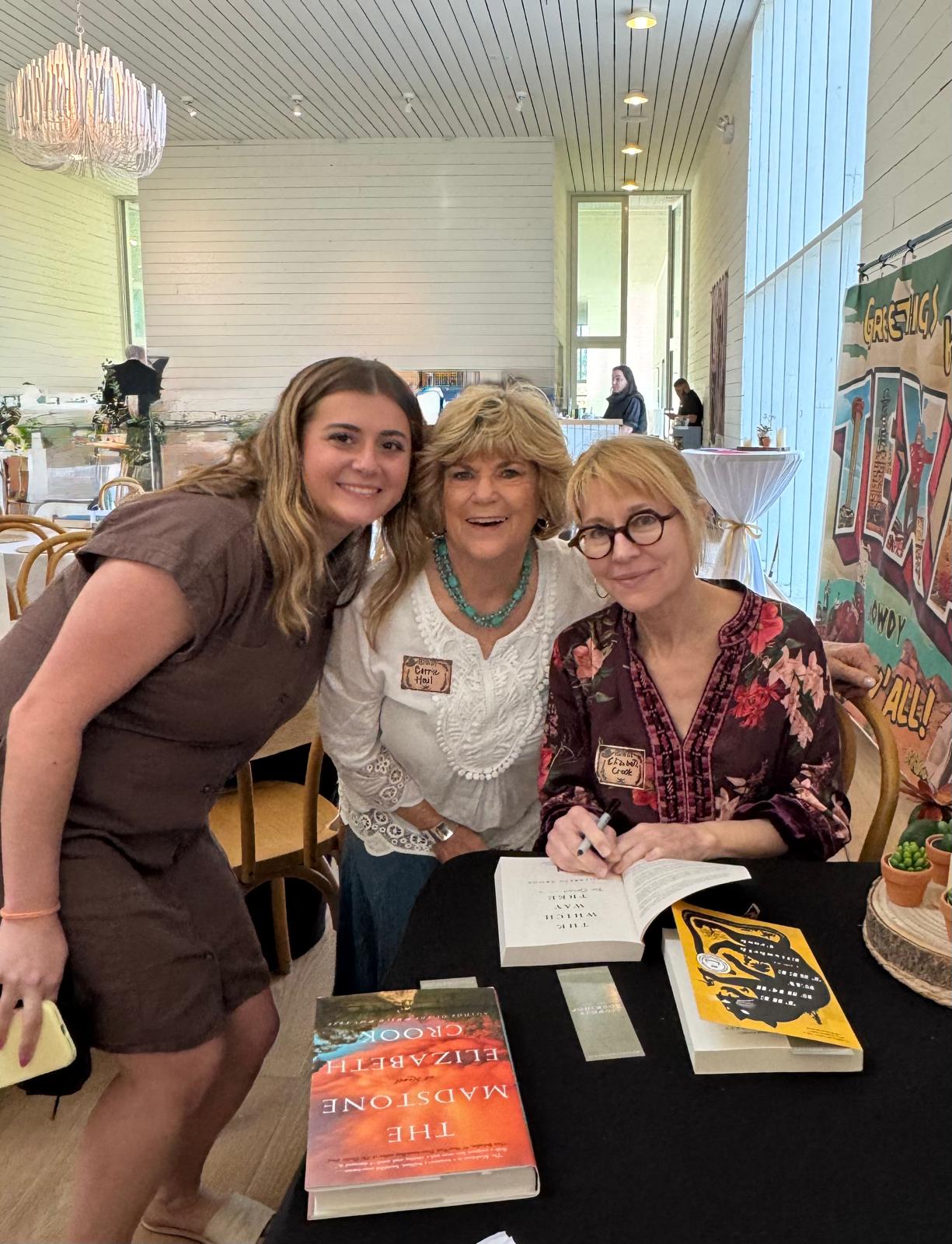 A book signing, with copies of The Madstone on the table